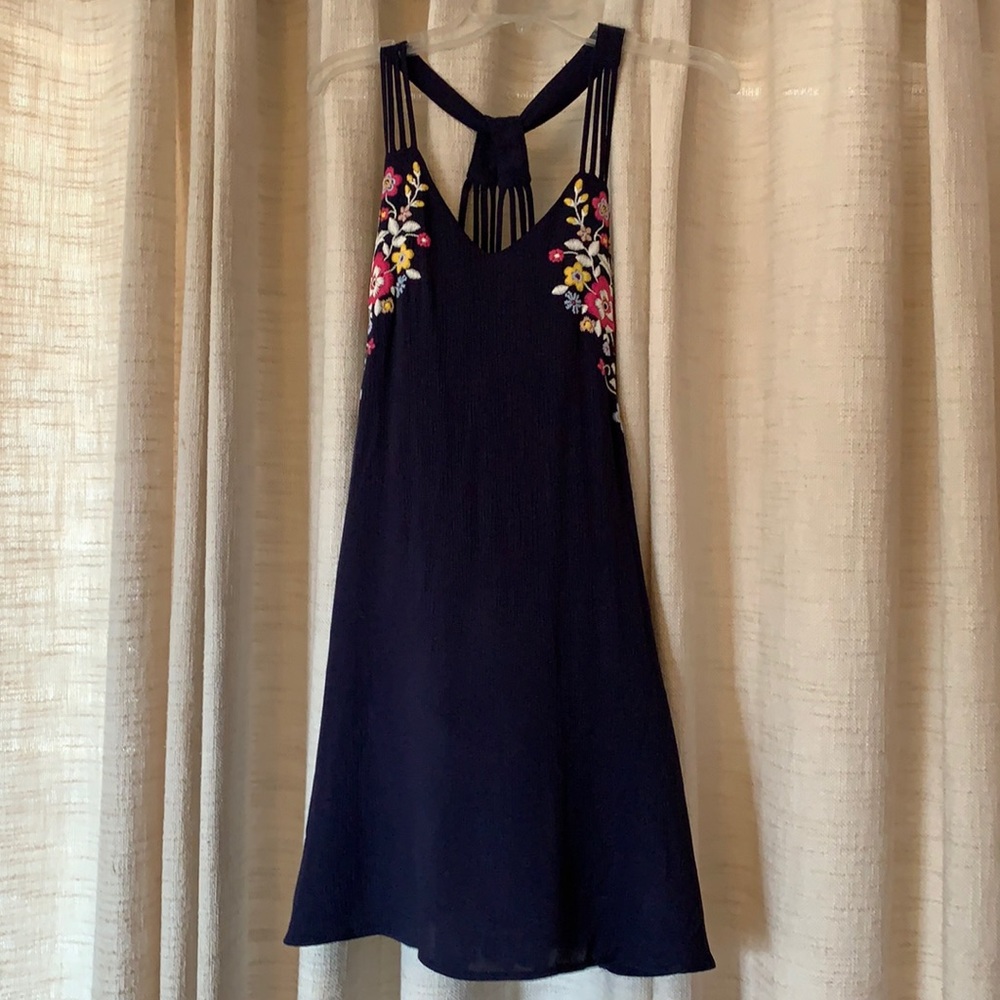 Blue sundress with embroidered flowers at top.